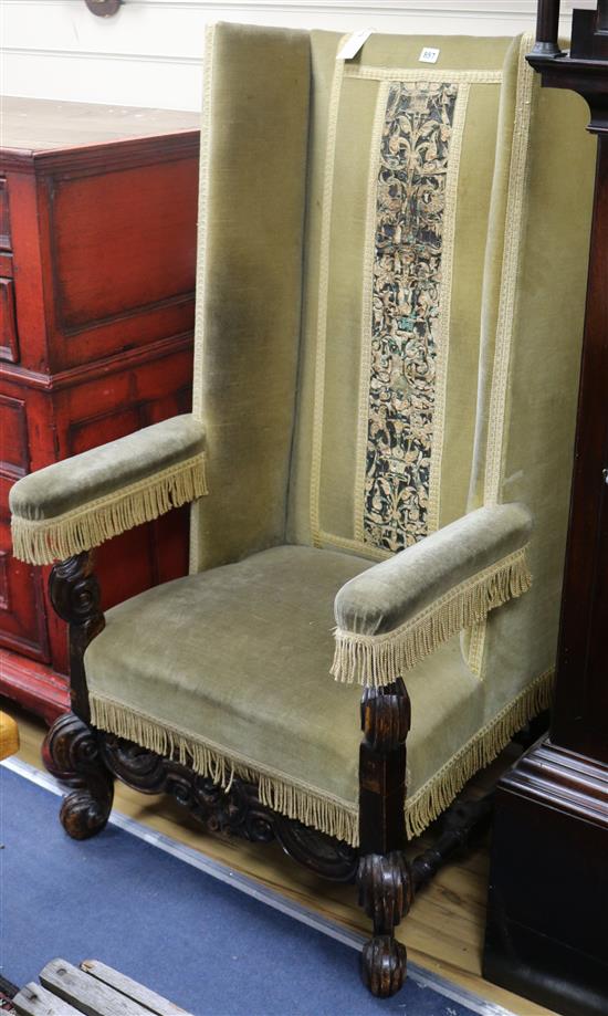 A Carolean design upholstered high backed armchair